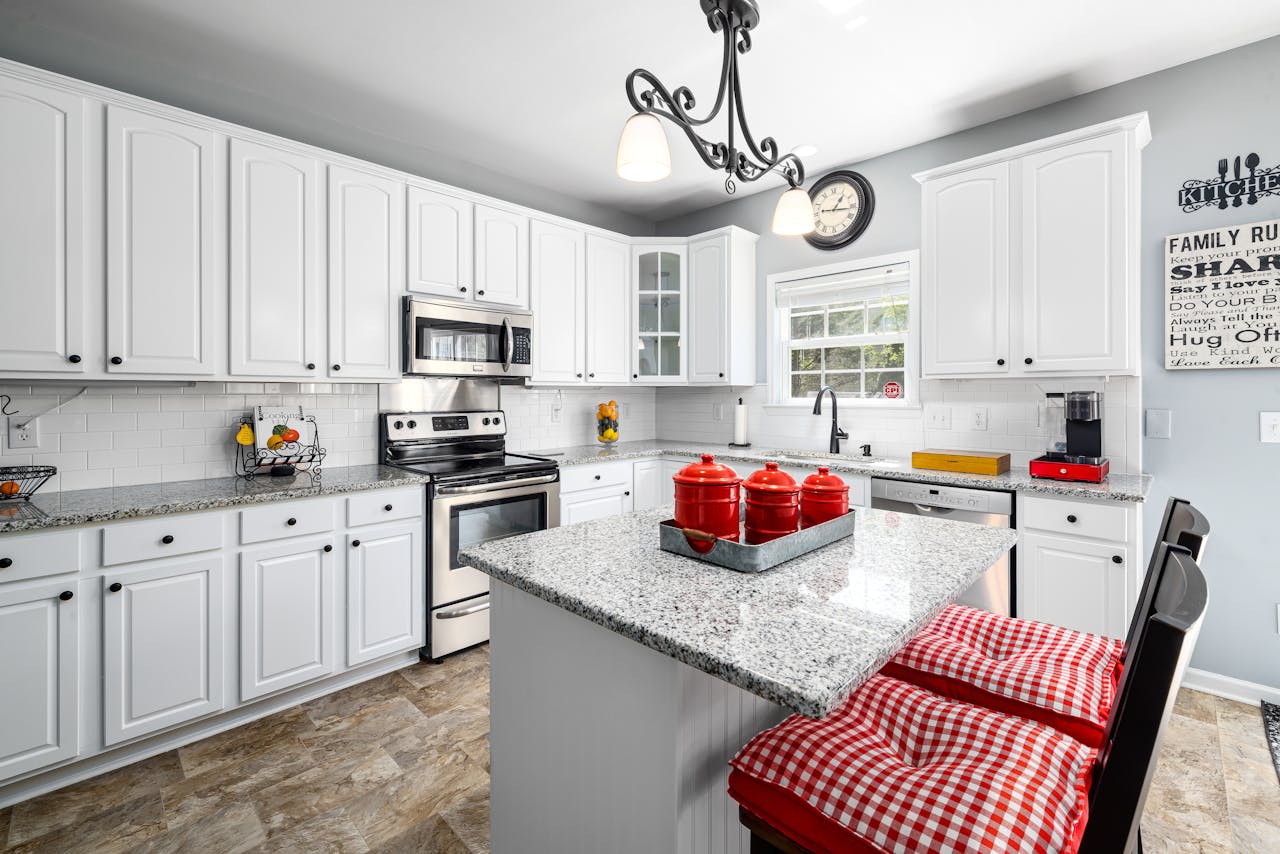 gallery-02 Bright modern kitchen featuring white cabinets and checkered bar stools.